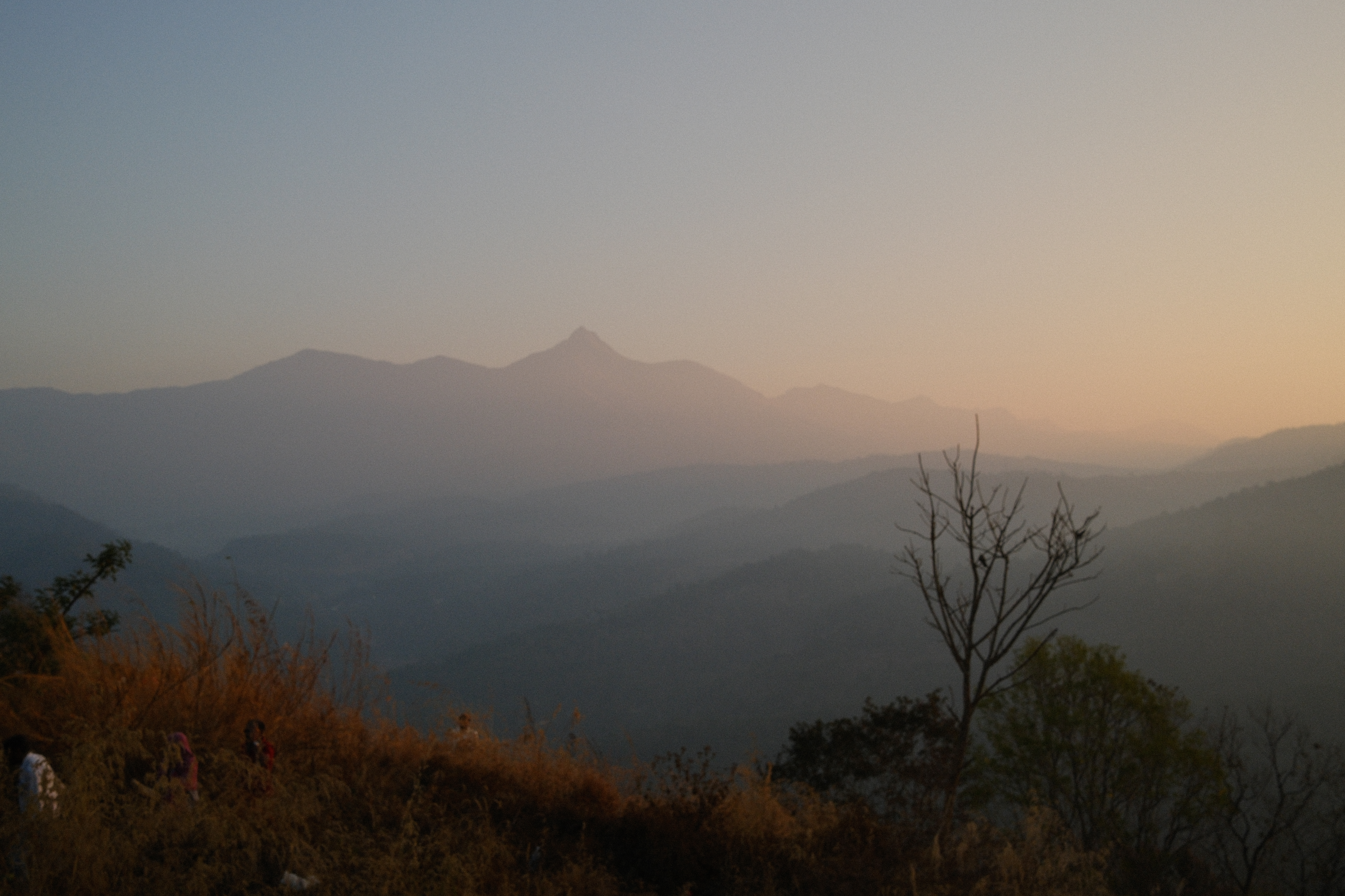 Elegant colonnade with rattan chairs and warm golden light